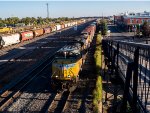 UP 8427 leads and eastbound manifest freight under the pedestrian overpass in Laramie